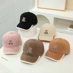Detail of colorful teddy fleece baseball caps with bear embroidery for kids