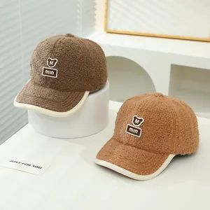 Close-up of plush lamb wool baseball caps with teddy bear embroidery and contrast trim