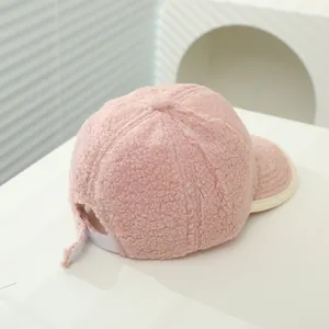 Detailed view of pink fleece baseball cap with adjustable strap and textured fabric