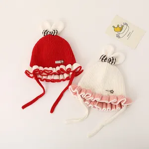 Bonnet d'hiver en tricot pour bébé avec oreilles de lapin et nœud à carreaux