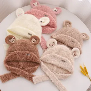 Detail of plush bear ear knit hats in five colors with soft fleece texture and long straps