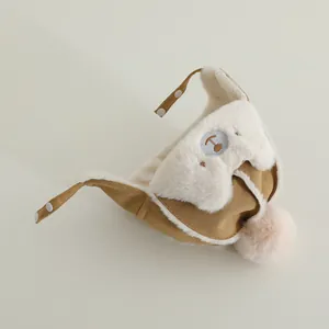 Detail of baby trapper hat with soft faux suede, plush lining and bear embroidery