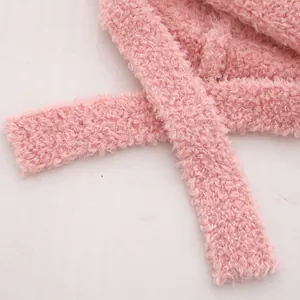 Macro shot of pink fleece material and stitching on kids' winter hat with ties