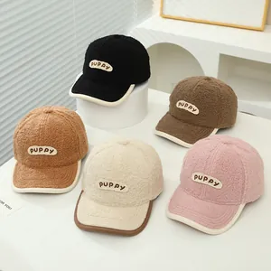 Detail showing five colors of sherpa fleece baseball caps with puppy letter embroidery