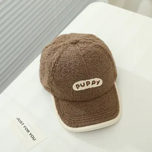 Detailed view of brown sherpa baseball cap featuring embroidered PUPPY patch and soft texture