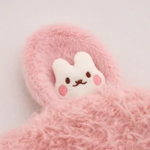 Close-up of pink plush winter hat featuring a soft white cartoon bunny embroidery