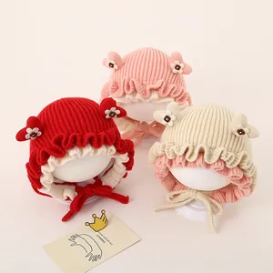 Cute baby knit hat with rabbit ears and heart pattern in red, pink, and beige colors