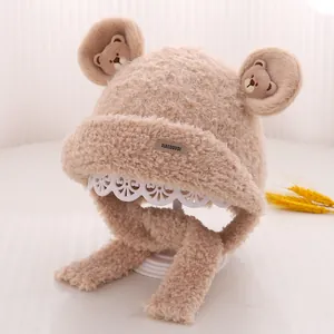 Close-up of plush bear ear winter hat with cute embroidery and soft chin straps