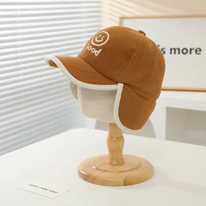 Détail du bonnet aviateur en polaire kaki avec broderie et rabats pour oreilles
