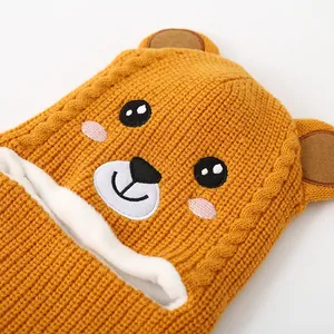Macro detail of ginger knit baby bear hat showing soft thick fleece lining for winter warm
