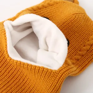 Detail of children's ginger knit hat showing thick white faux shearling fleece lining