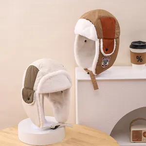 Detail view of winter windproof aviator hats with plush lining and ear flaps for kids