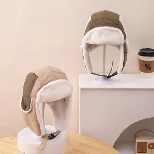 Detail of color-block kids winter trapper hats with thick faux fur lining and windproof fabric
