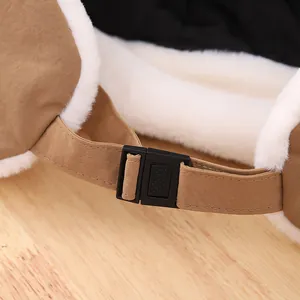 Detail of adjustable chin strap buckle on a winter trapper hat with warm faux fur lining