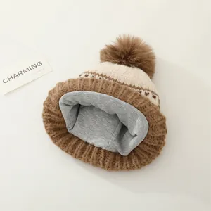 Detailed view of the winter knit hat featuring a plush fleece lining and faux fur pom-pom