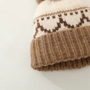 Close-up of knit winter hat showing textured cream and brown geometric patterns