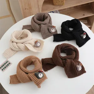 Détail d'écharpes en tricot en cinq couleurs avec mignons écussons d'oursons
