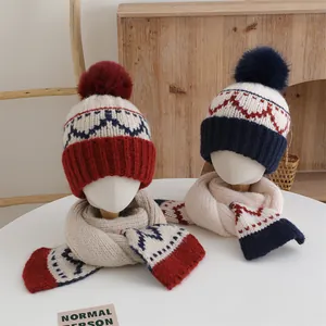 Winter knit pom-pom hat and scarf set for children with geometric diamond patterns