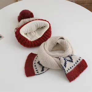 Detail of warm winter knit hat with red pompom and thick white fleece lining interior