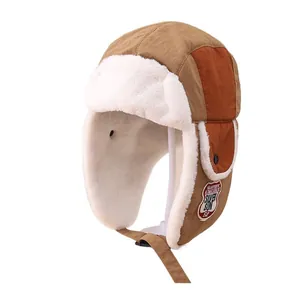 Winter trapper hat for kids with brown windproof fabric and thick white faux fur lining