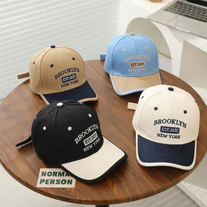 Detailed view of kids cotton baseball caps with Brooklyn embroidery in four color variants