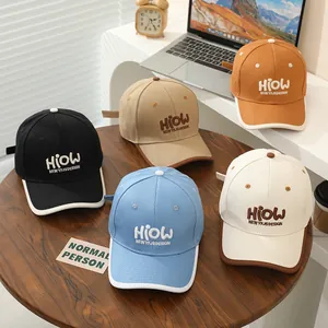 Detailed embroidery of HIOW letters on colorful kids cotton baseball caps in various colors