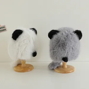 Detailed plush animal ear hats for babies in white and grey colors on wooden stands
