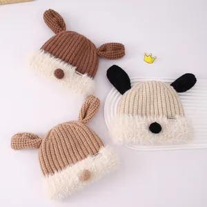 Detailed view of three knit baby hats with dog ears and soft faux fur lining in soft colors