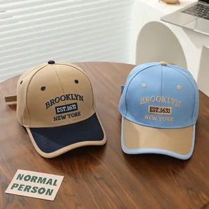 Detail of embroidered Brooklyn logo and premium stitching on two-tone kids baseball caps
