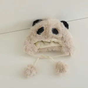 Detail of baby panda faux fur trapper hat with soft plush texture and pom-pom chin straps