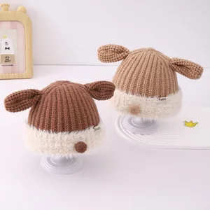 Close-up of thick knit baby hats with plush fleece trim and cute ear accents