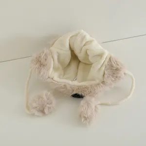 Plush beige panda style aviator hat for kids featuring faux fur trim and pompom ties