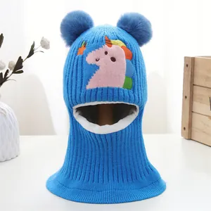 Close-up of blue knit baby balaclava with unicorn patch and plush fleece lining