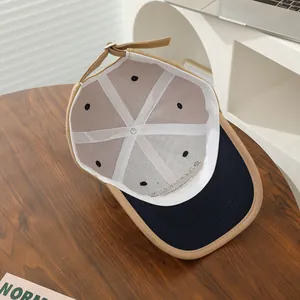 Internal view of a cotton baseball cap with reinforced seams and adjustable metal buckle strap