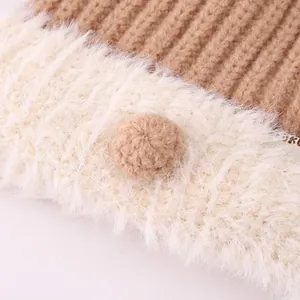 Winter knit baby hat with warm earflaps and brown pom-pom detail on white faux fur lining