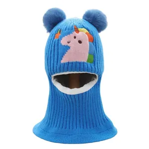 Blue winter baby balaclava hat with dinosaur embroidery and two fluffy pom-poms