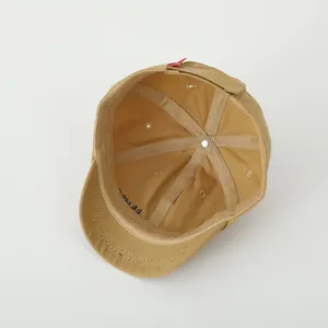 Detail view of khaki toddler baseball cap interior with adjustable velcro strap and cotton lining