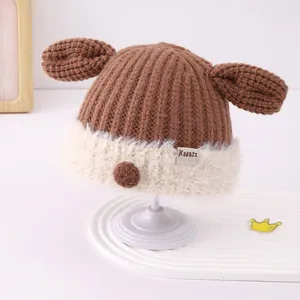 Detailed view of winter baby knit hat featuring cartoon animal ears and plush white trim
