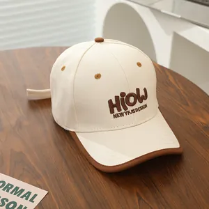 Macro view of beige canvas baseball cap with brown HIOW 3D embroidery on wooden surface