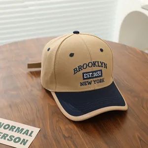 Close-up of the cotton twill embroidery detail on a two-tone Brooklyn baseball cap