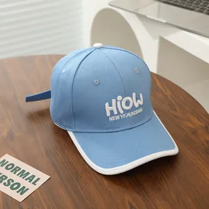 Detail of blue baseball cap with HIOW 3D embroidery on canvas and white contrast brim