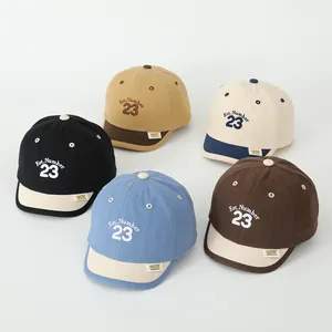 Flat lay of five assorted cotton baseball caps for toddlers featuring Est. Number 23 embroidery