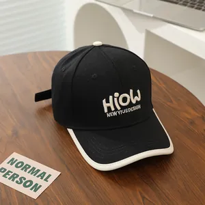 Detail of contrast stitch HIOW embroidery on black adjustable baseball cap for kids