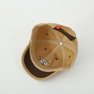 Internal view showing Number 83 embroidery and red label on the khaki baseball cap