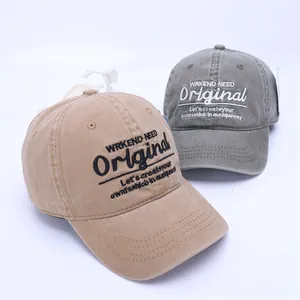 Detail of khaki and gray-green washed cotton baseball caps with vintage embroidery
