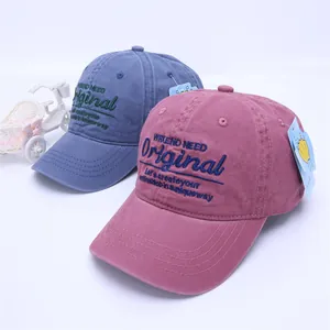 Detailed close-up of embroidered canvas baseball caps with premium washed fabric texture