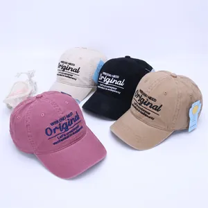 Detailed group view of four washed cotton baseball caps in assorted vintage colors