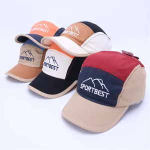 Detail view of colorful 5-panel kids baseball caps with sport embroidery and panel textures