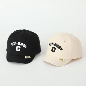 Detailed embroidery of HI! BABY text on cotton baseball caps for toddlers