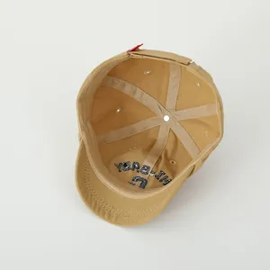 Detail view of khaki toddler baseball cap interior with stitching and velcro strap
